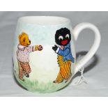 Cricket mug. A small hand painted china mug by Joan Allen featuring two golliwogs and a teddy bear