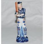 Cricketing figure. Continental highly decorative bisque blue and white figure of a young