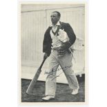 Don Bradman. Mono photograph of Don Bradman walking out to the nets, dressed in cricket attire,