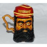 'W. G. Grace'. Ceramic caricature toby jug depicting Grace with separate lid formed as his striped