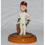 Sir John Berry Hobbs. Ceramic caricature figure of Hobbs in cricket attire holding bat with name
