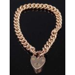 A 9ct gold curb link bracelet having heart shaped padlock clasp and safety chain, 31.6g