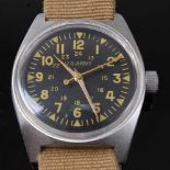 A Vietnam War U.S. Army steel cased wristwatch, having a black dial with luminous Arabic numerals
