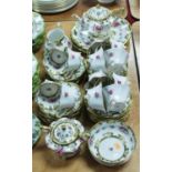 An early 20th century continental porcelain 12 place setting tea service on a white ground with pink