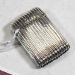 A late Victorian silver vesta, of hinged rectangular form, having reeded decoration and gilt-