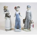A Lladro Spanish porcelain figure of a young boy in standing pose with a pail in each hand, having