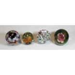 A collection of four modern glass paperweights