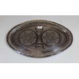 A 20th century Eastern white metal tray of oval form, the centre decorated with two 7 point stars