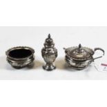 An Edwardian silver three-piece cruet, comprising mustard, open salt with blue glass liner, and