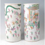 A pair of Chinese famille rose cylindrical vases, each decorated in bright enamels with ceremonial