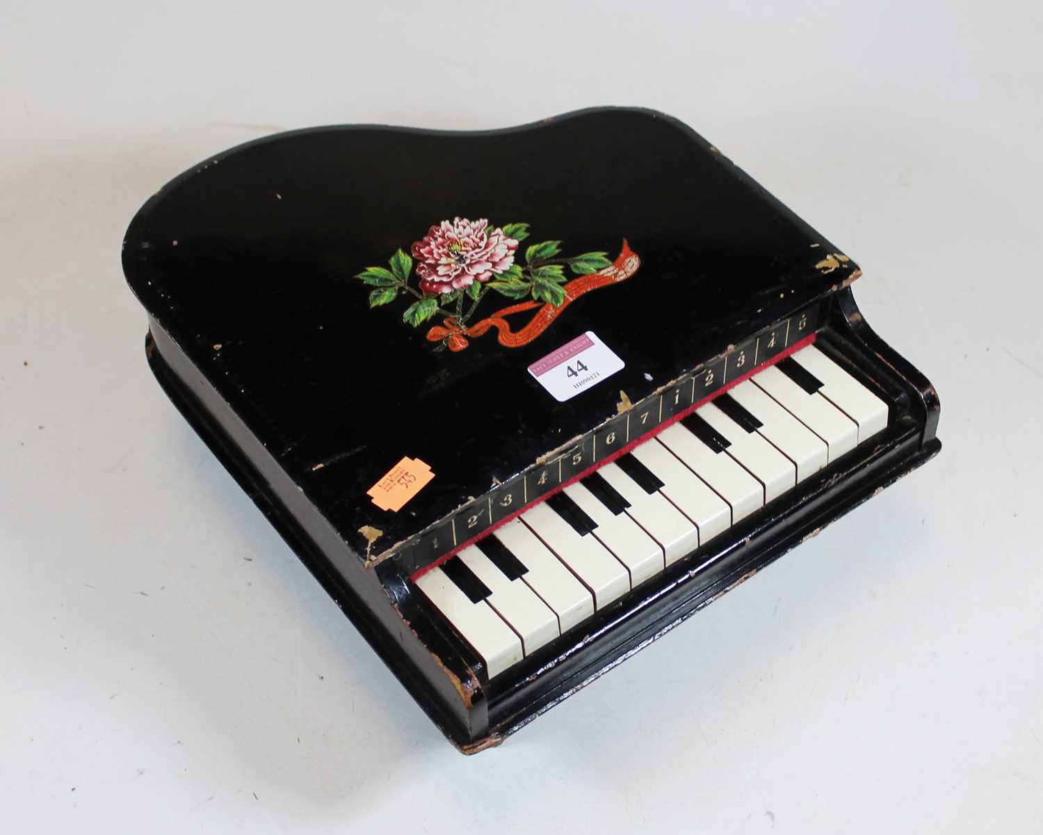 An early 20th century child's toy xylophone, in the form of a miniature grand piano, with floral and