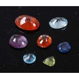 A box of loose faceted gemstones, to include a sapphire, an amethyst, a blue topaz, a peridot, two