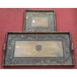 An early 20th century oak twin handled drinks tray of rectangular form carved with leaves and