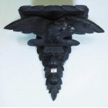 A Victorian style ebonised wall bracket carved as an eagle, height 49cm