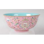 A Chinese porcelain pink ground bowl, enamel decorated with flowers and foliage, later Qianlong mark