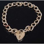 A 9ct gold curb link bracelet with heart shaped padlock clasp and safety chain, 15.7gCondition