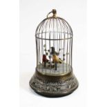 An early 20th century bird automaton, the brass case in the form of a bird cage surrounding three