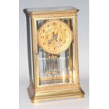 A circa 1900 gilt brass four glass clock by Guichard of Chalon-Sur-Saône, the case with applied