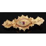 A late Victorian Etruscan style 9ct gold memorial brooch, having a centre navette shaped panel set