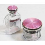 A George V glass dressing table jar, the silver cap with pink guilloche enamelled top; together with