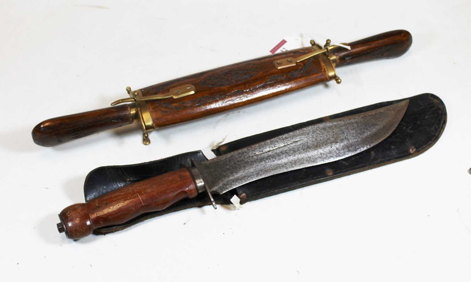 A 20th century wooden handled bowie knife, with leather sheath; together with a carved hardwood