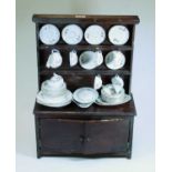 A 20th century child's stained beech dresser, having a two-tier plate rack with cupboards below;