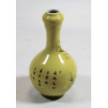 A Chinese porcelain bottle vase, of onion shape, on a yellow ground decorated with prunus, having