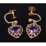 A pair of yellow metal amethyst drop earrings, each featuring a heart shaped amethyst with a