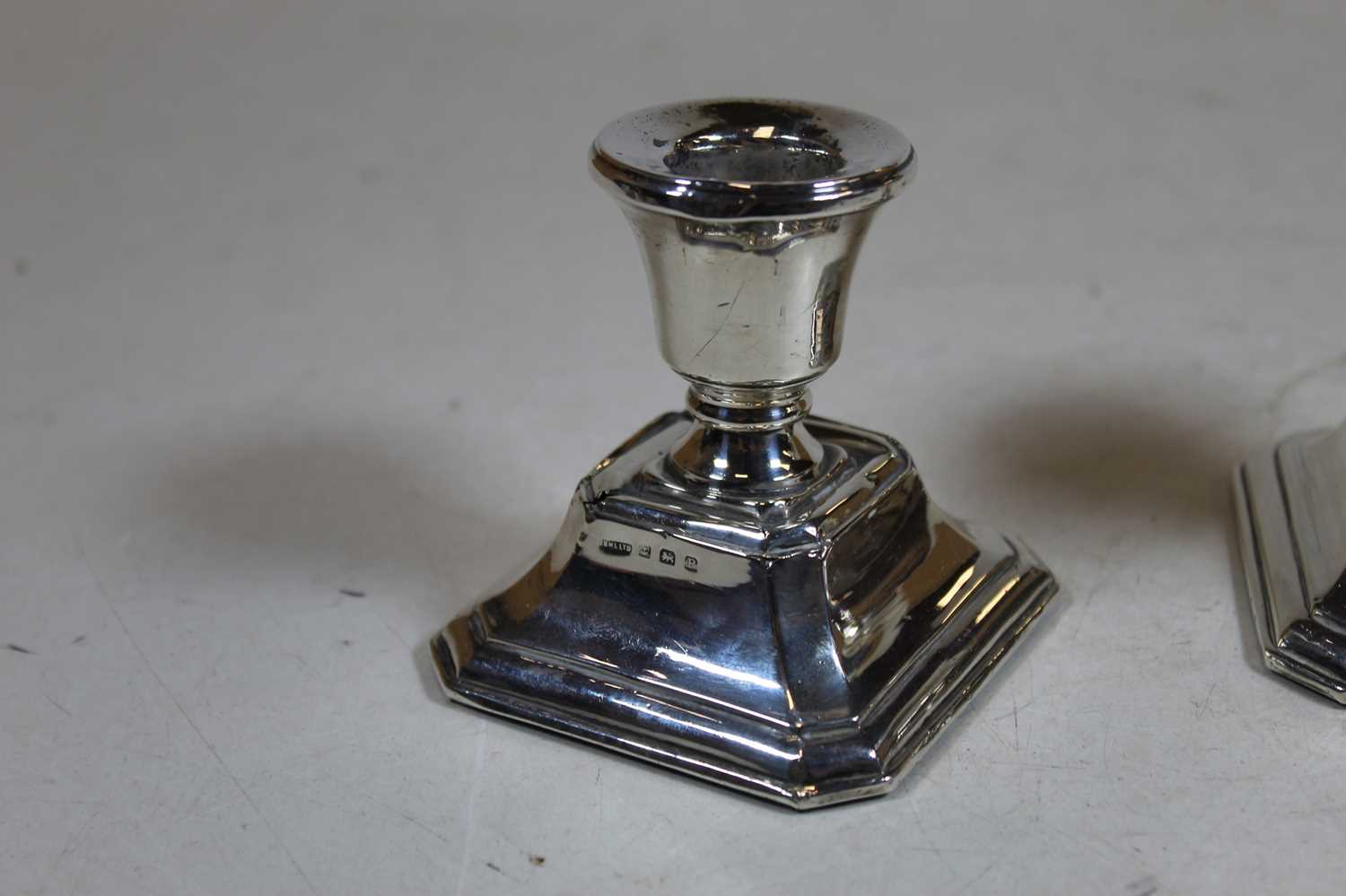 A pair of George V silver dwarf table candlesticks, each on a loaded base, h. 7.5cmCondition report: - Image 2 of 15