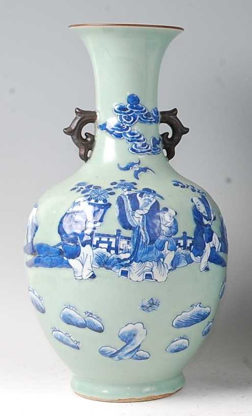 A Chinese export celadon ground baluster vase, having raised blue and white figure and cloud