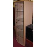 A contemporary beech double door glazed bowfront freestanding display cabinet, having four