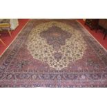 A large Persian woollen cream ground Tabriz carpet, the stylised floral ground within trailing
