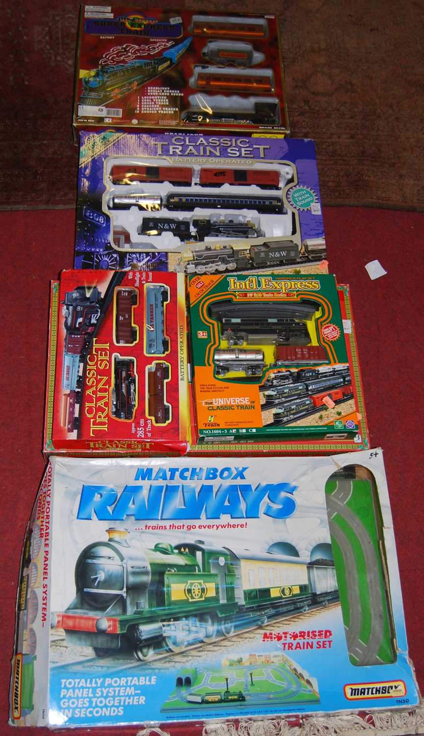 A boxed Matchbox train set, a North Pole Holiday Express boxed train set, and three various others
