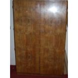 An Art Deco walnut and figured walnut round cornered double door wardrobe, w.123cmCondition
