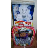 A boxed Cabbage Patch Kids doll, one other and a 25th Anniversary Care Bear