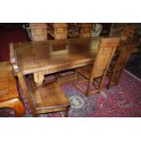A good 17th century style joined oak four plank refectory dining table, the cleated ends raised on