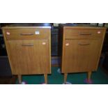 A pair of 1950s light oak single door bedside cupboards, each with single upper drawer, w.41cm