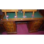 A mid-Victorian walnut and burr walnut twin pedestal writing desk, having gilt tooled green