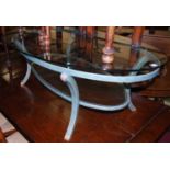 A contemporary heavy plate glass topped and burnished metal framed oval coffee table, having