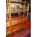 A Chinese stained pine freestanding display stand, of typical tiered form, with three central