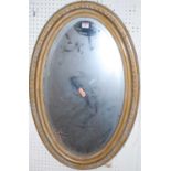 A gilt framed oval bevelled wall mirror, with egg & dart moulded edge, 81 x 52.5cm