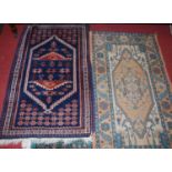 A small Turkish woollen blue ground hall rug, having stylised geometric ground, 135 x 81cm; together
