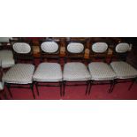 A set of six circa 1900 ebonised and upholstered pad back and seat parlour side chairs