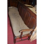 An 18th century five panelled oak long settle (partially converted to daybed), width 200cm