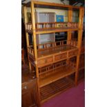 A Chinese stained pine freestanding display stand, of typical tiered form, with three central