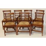 A set of six early 19th century elm and rush seat ladderback dining chairs and a matching elbow