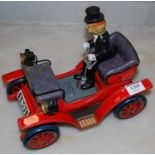 A 20th century battery operated tinplate car with driver