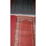 A Persian woollen green ground Bokhara rug (with wear), 187 x 126cm; together with a Persian woollen