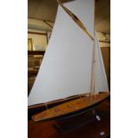 A scratch-built model classic sailing yacht, raised on integral stand, max h.108cm, max length 99cm