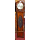 A 1930s beaded oak grand-daughter clock, having striking and chiming movement, with oval glazed